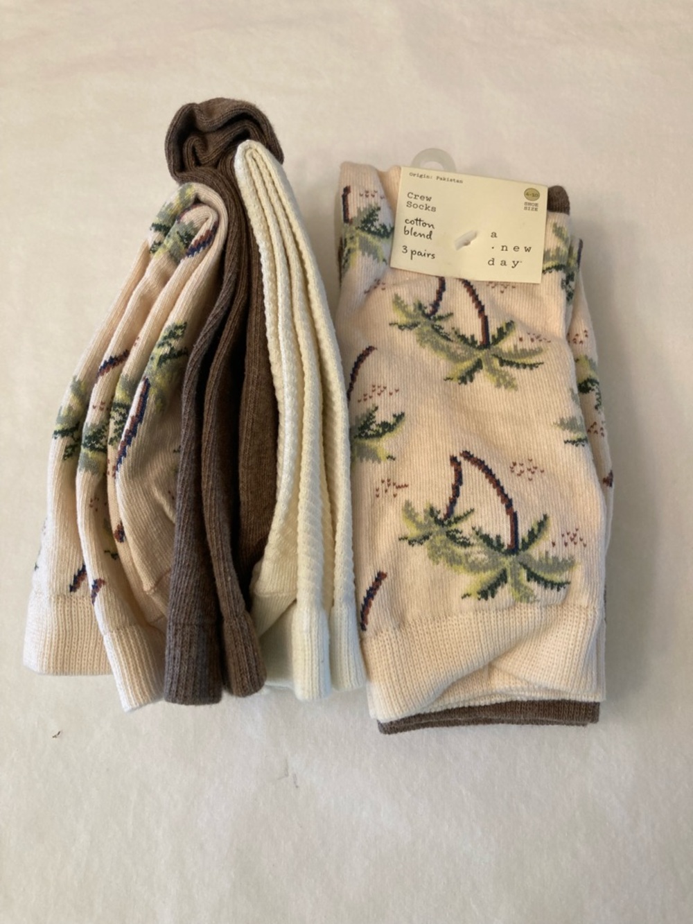 2 packs of A New Day Palm Women’s Print and Solid Brown and cream colored socks.